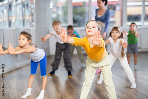 Εκτύπωση καμβά Energetic happy children practicing modern vigorous movements in dance class