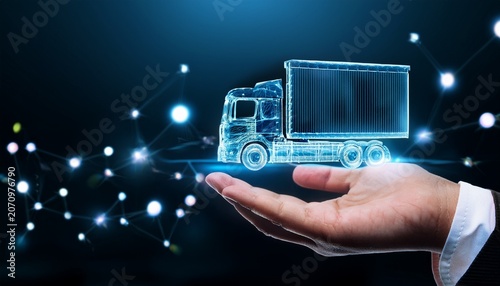 hand holding miniature truck with digital logistics and delivery technology concept