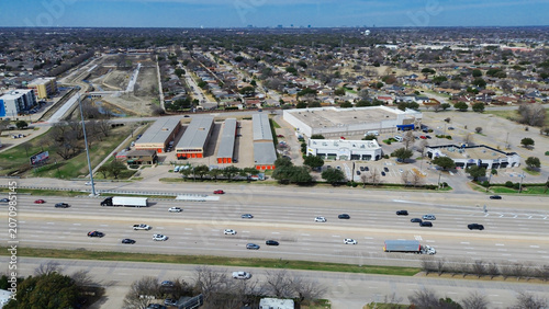 Urban transit lifestyle capture extensive North Central Expressway traffic flowing past commercial retail hubs. Clear highway sightlines contrast with surrounding residential area, Plano, TX