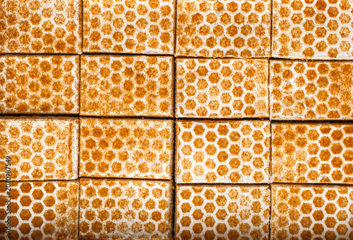 Pieces of honey cake with cream, cake background. Sweets, dessert and pastry, close up, top view