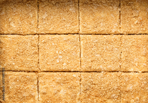 Pieces of Napoleon cake with cream and nuts, Napoleon background. Sweets, dessert and pastry, close up, top view