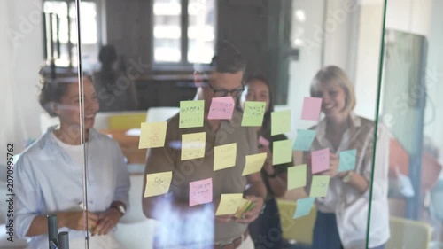 Diverse business team brainstorming ideas using sticky notes
