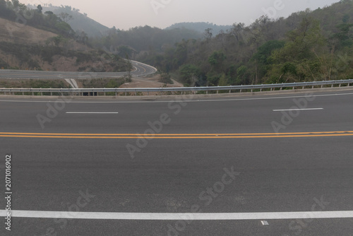 Asphalt road side view and beautiful natural panoramic countryside landscape with mountains.