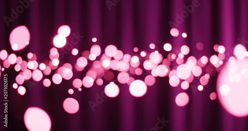 Floating pink bokeh lights glowing against a dark purple curtain background.