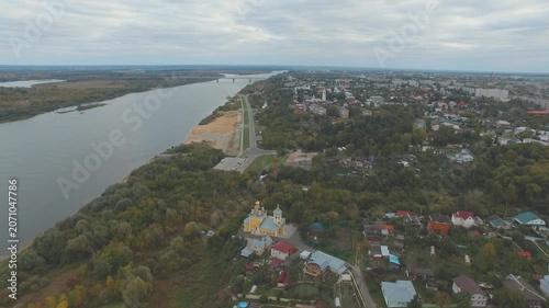 Backward drone flight above Murom embankment