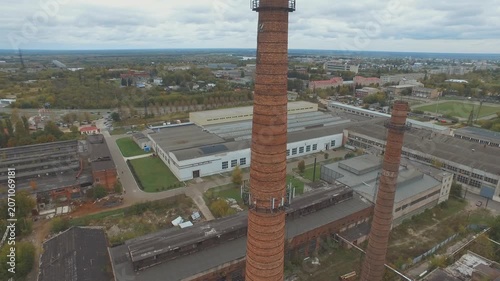 Sideways drone over factory chimneys