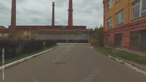 Drone retreating low over industrial road