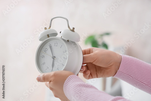 Female hands changing alarm...