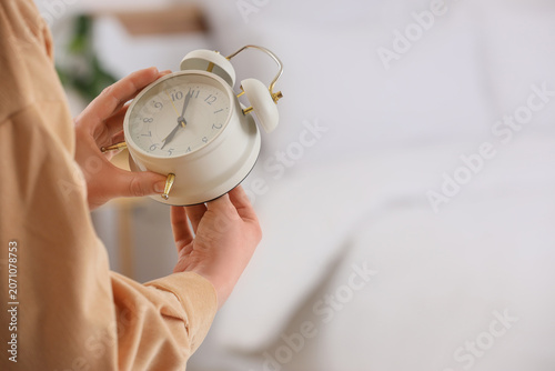 Woman changing clock for da...