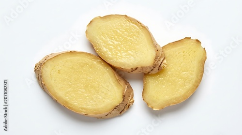 Fresh Sliced Ginger Root Halves on White Surface