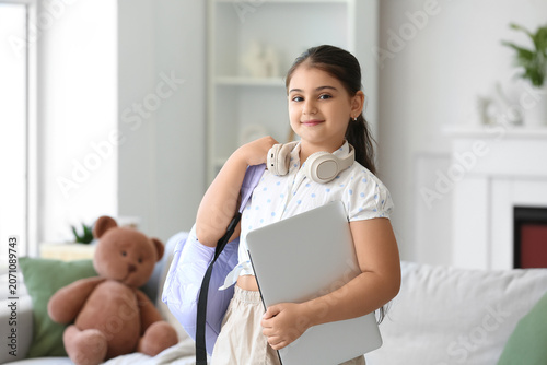Little schoolgirl with lapt...