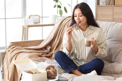 Young Asian woman with cup ...