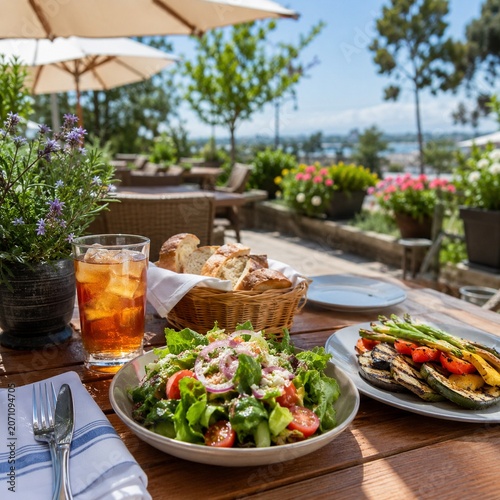 Sunny outdoor restaurant patio lunch table with salad and iced tea