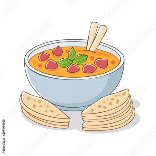 Bowl of soup with flatbread and herbs