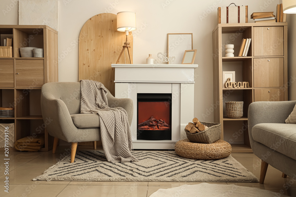 Obraz premium Interior of cozy living room with armchair, fireplace and shelving units