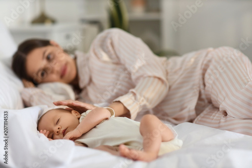 Cute little baby with mothe...