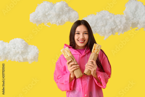 Young Asian woman in rainco...