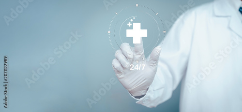 Doctor touching virtual healthcare interface with medical cross icon. Digital health technology, 24/7 medical services, telemedicine, AI healthcare and patient care concept.