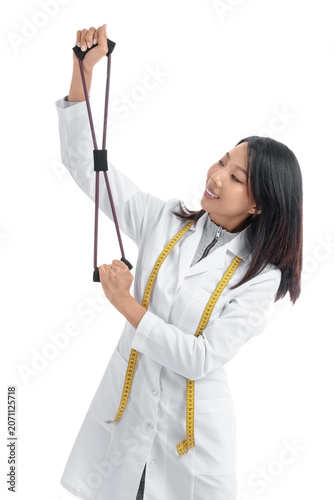 Female Asian nutritionist with fitness expander on white background