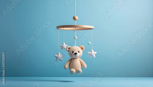 Dreamy nursery scene featuring a teddy bear mobile with soft pastel background