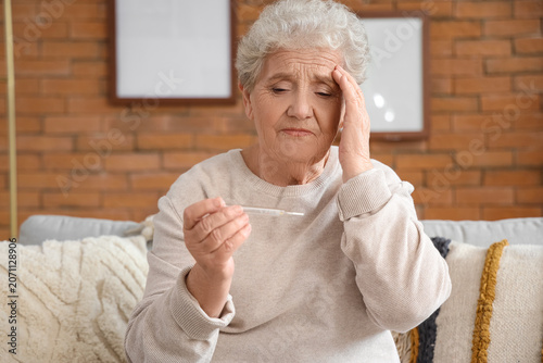 Ill senior woman with therm...