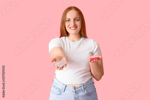 Young woman with condom and...