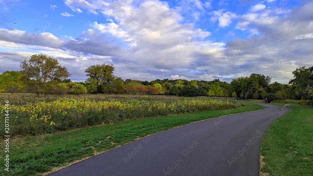 Naklejka premium Running in the park on a beautiful summer evening. Credit Meadows. Mississauga, ON, Canada