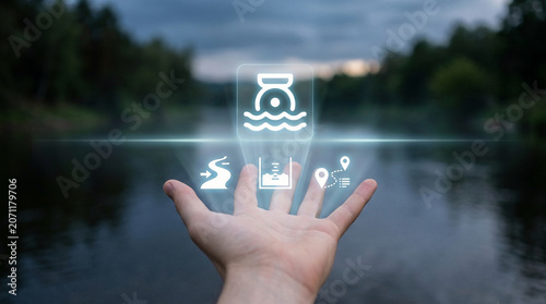 Smart water monitoring system concept showing holographic icons of river levels and sensors over a person's hand in a natural environment at dusk.
