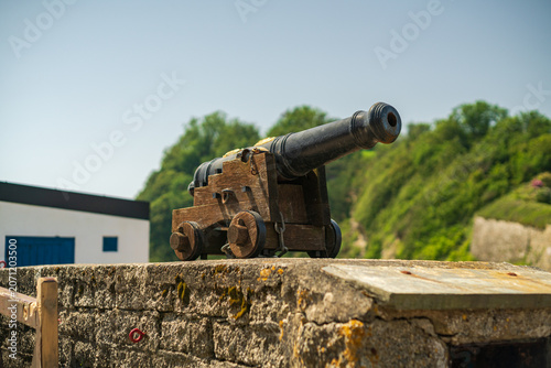 Fotografie Historic Naval Cannon Displayed Atop Stone Wall In Charletown Harbour