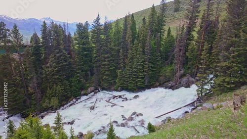 Lake Creek mountain river flows harshly through rocky terrain along the Beartooth Highway in Wyoming