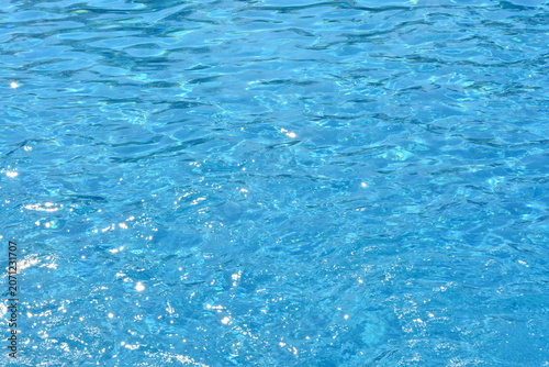 Sparkling Blue Swimming Pool Water with Sunlight Reflections