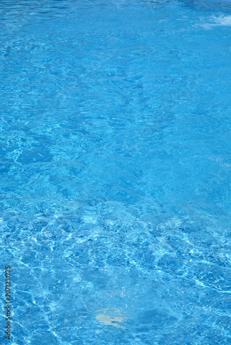 Clear Blue Swimming Pool Water with Sunlight Reflections