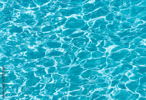 Sunlight reflections on turquoise swimming pool water surface with turquoise reflection sunlight swimming abstract background transparent refreshing vacation clearwater relaxing wellness