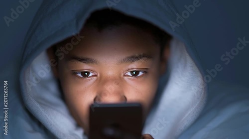 How much screen time is harmful to your child? Black minor with a gadget