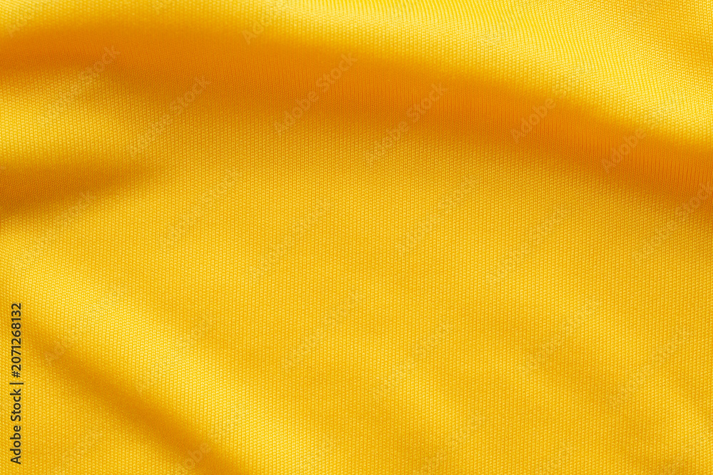 Fototapeta premium Yellow sports clothing fabric football shirt jersey texture