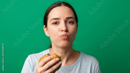 Woman Eating Burger with Surprised Expression