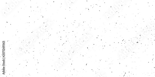 Obraz na plátně A collection of small, dark particles are scattered across a white background