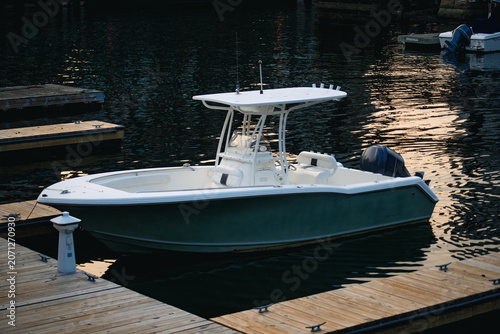 View of a white center console motorboat moored at a wooden dock in the South Boston Waterfront, Boston, Massachusetts, United States.