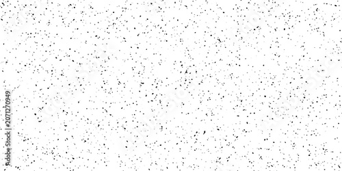 Tableau sur toile A close-up macro shot reveals a textured white surface speckled with numerous dark, random flecks, creating a subtle, abstract pattern