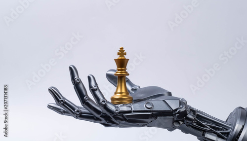 Fotografija Futuristic robotic hand holding chess king piece on minimal background, symbolizing artificial intelligence leadership, strategic decision making, competitive advantage in modern business technology