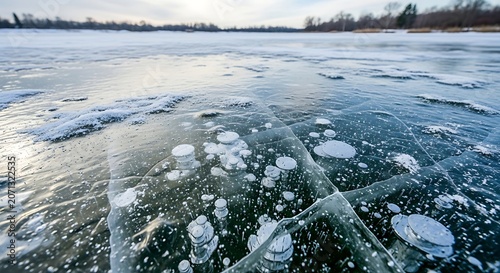 Frozen Lake with Ice Bubbles and Snow Cover.