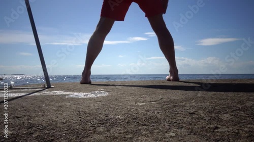 Borgholm, Sweden A man does callisthenics on a pier on the Baltic Sea. 