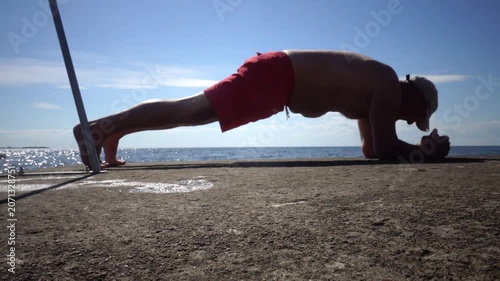 Borgholm, Sweden A man does callisthenics on a pier on the Baltic Sea. 