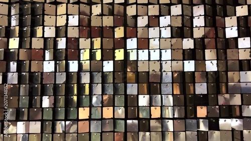 Abstract light reflections shimmering from decorative metallic ornaments, creating sparkling patterns, glittering highlights and a festive atmospheric background