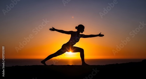 Silhouette of woman practicing yoga warrior pose on mountain top during sunset