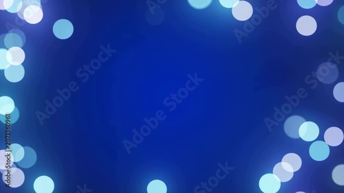 Abstract blue bokeh particles frame background with central copy space for text