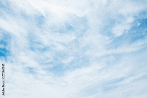 the sky is clear blue with fluffy white clouds, the sky is very bright, and the sun shines.