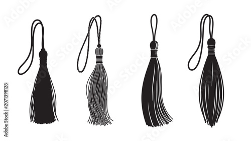 Set of four black and white decorative tassels with elegant looped tops.
