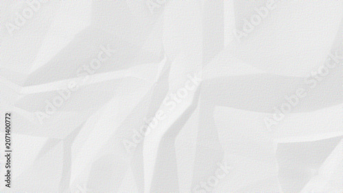 Abstract background of crumpled white paper with subtle shadows and highlights