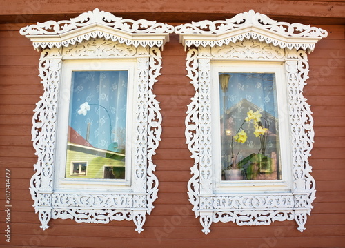 The windows are decorated with wooden carved architraves